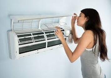 Woman with broken air conditioner